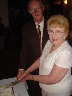 Mum and Dad cutting the cake