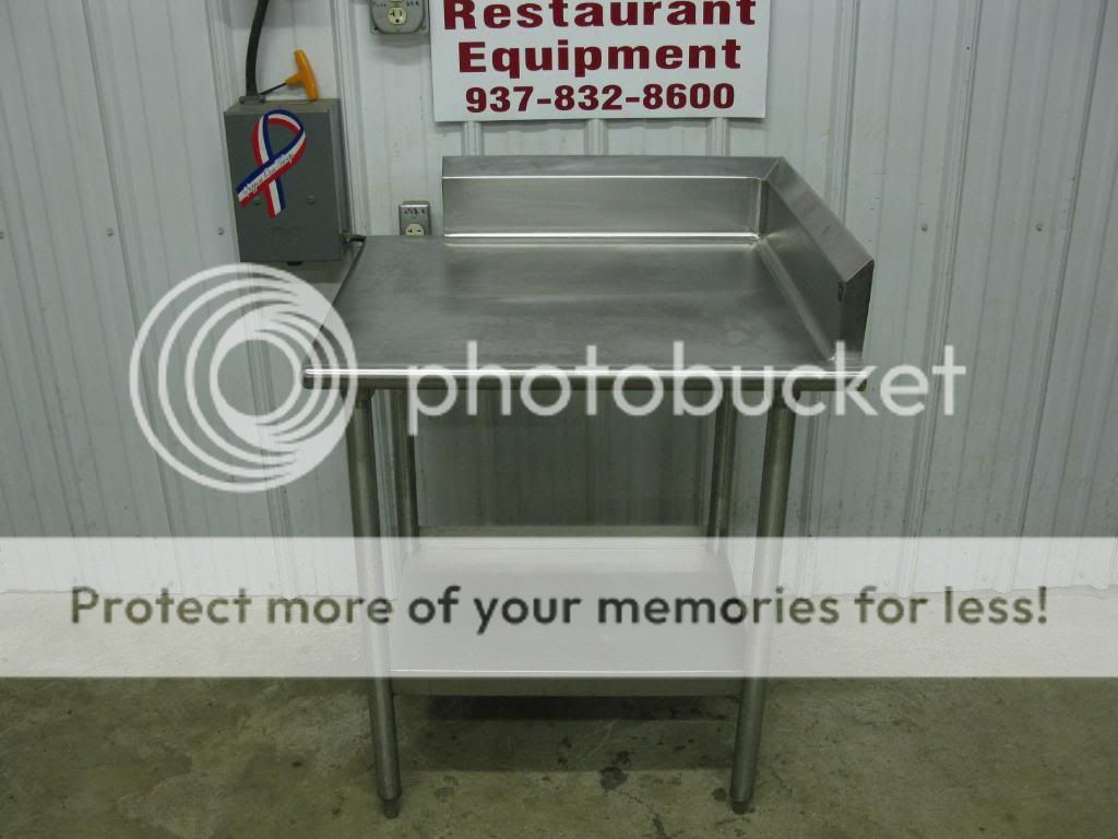   looking at a stainless steel corner work table w/ side & back splash